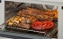Potente Churrasqueira Infravermelha: permite grelhar, gratinar e preparar deliciosos churrascos rapidamente e sem fumaça.